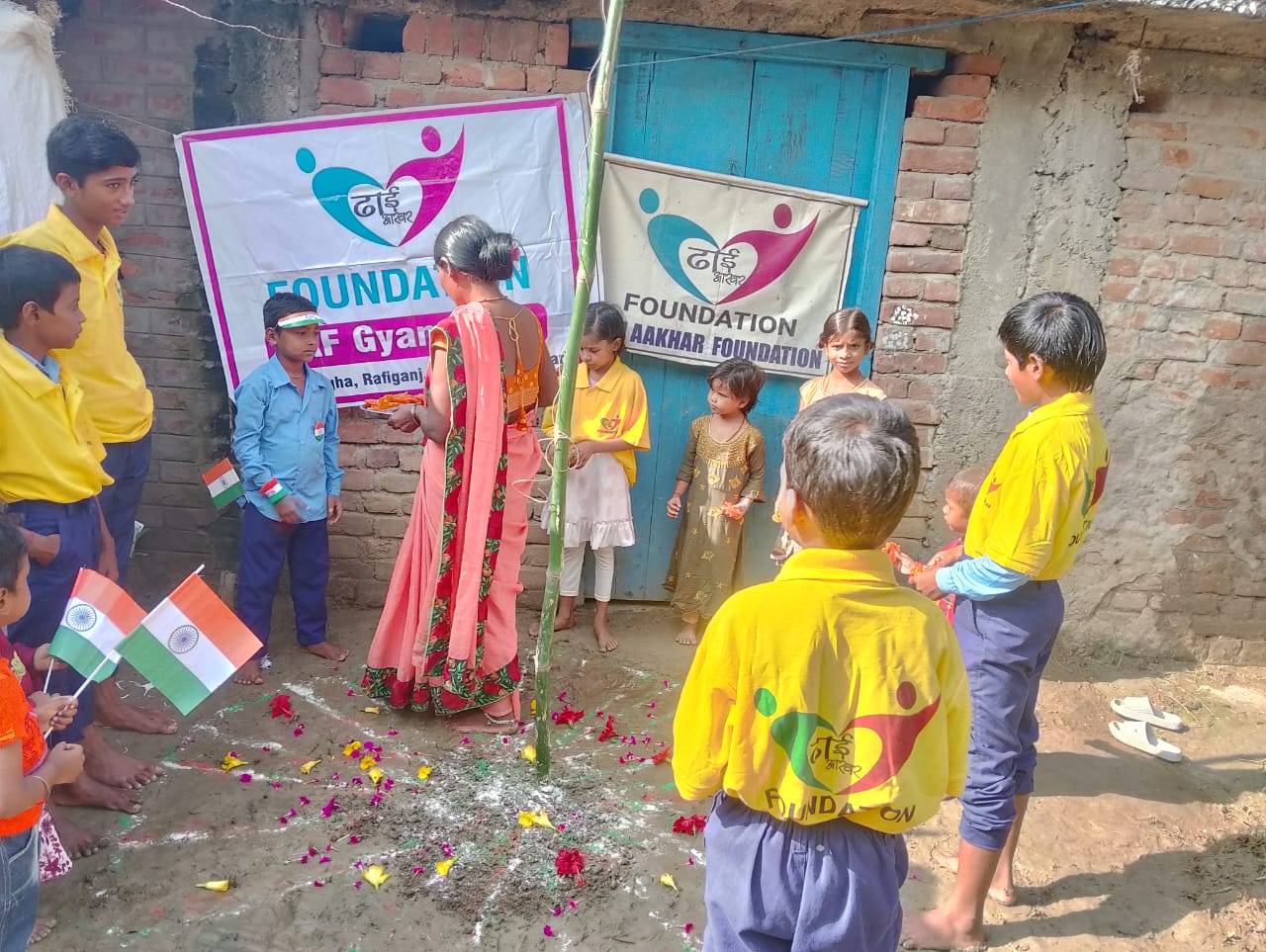 Children gathered near banners of Dhai Aakhar Foundation and Gyanodaya.